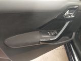the door handle of a car is open and the door handle is empty