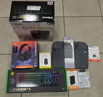 a box with a keyboard, mouse, mouse pad, and other items on the floor
