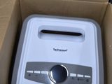 a white toaster sitting inside of a cardboard box