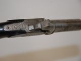 an old gun that has been engraved with a design on it