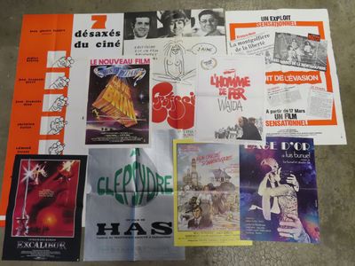 various movie posters are displayed on a table in a room