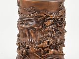 an image of a wooden vase with carvings of animals and flowers