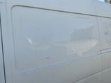 a white van that is parked on the side of the road