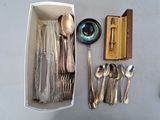 a lot of silverware in a box on the table