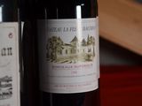 two bottles of wine sitting next to each other on a table