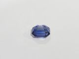 a close up of a blue sapphire stone on a white surface