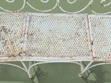 a white bench that is sitting on a green surface