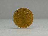 a close up of a gold coin on a white surface