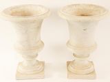 two white vases sitting next to each other on a white surface