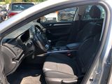 the interior of a car with the door open and the driver ' s seat down