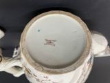 a close up of a cup with a handle on a table