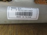 a label on the back of a sewing machine on a table