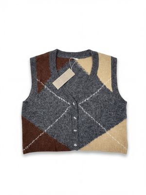 Ce gilet est en laine et présente un motif en patchwork