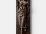 a wooden plaque of a woman holding a flower