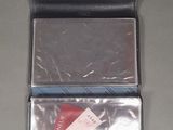 a black wallet with a red card in it on a table