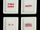 four square white dishes with pink and white designs on them