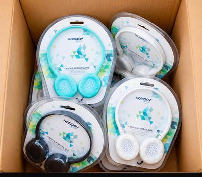 a cardboard box with headphones and earphones in it