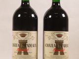 two bottles of chateau pradau wine sitting next to each other