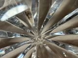 a close up view of a crystal plate with a starburst design