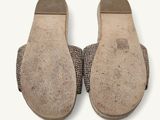 pair of shoes on a white surface with a white background