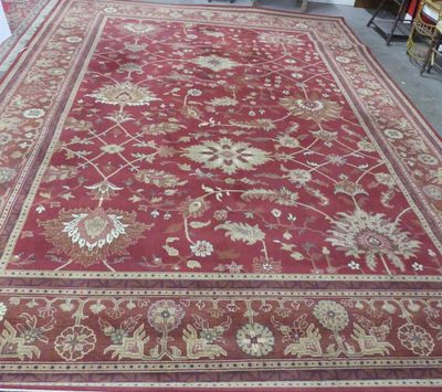 a large red rug on the floor in a room