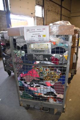 a cart with many items in it in a warehouse