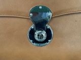 a close up of a brown bag with a lock on it