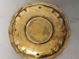 a gold plate on a white table with a white table cloth