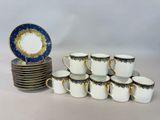 a lot of cups and saucers sitting on a table