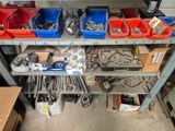many different tools on a shelf in a garage