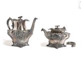 pair of silver plated teapots with handles and handles