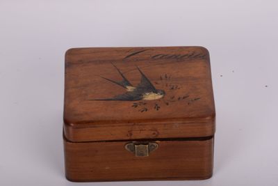 a small wooden box with a bird on it