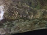 a bronze statue of a dog with a name on it
