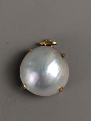 PENDENTIF en or jaune (750/°°°) serti d'une demi perle.
