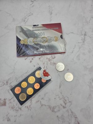 a card and some coins on a marble table