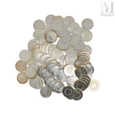 un tas d'argent et de pièces d'argent posé sur une surface blanche