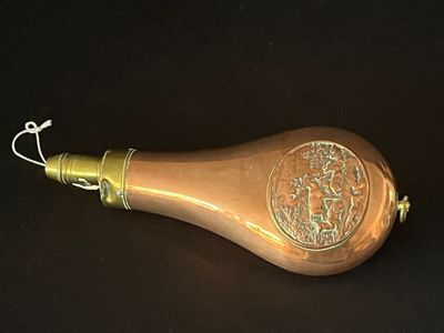 a small brass object on a black surface