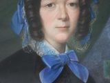 portrait of a woman with a blue bow in a black dress