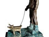 bronze statue of a man with a dog on a leash