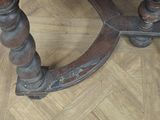 a wooden table with a clock on it on a parquet floor
