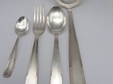 five silver spoons and two silver spoons on the table