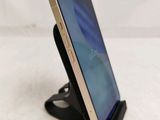 a phone that is sitting on a stand on a table
