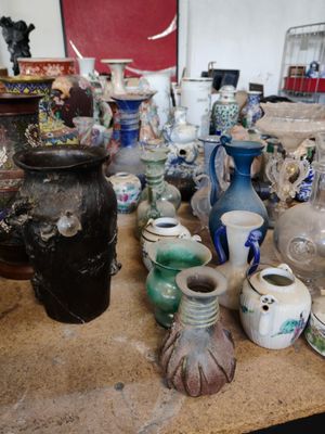 de nombreux vases différents sur la table de cette pièce
