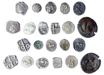 several different types of silver coins are shown on a white surface