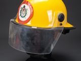 yellow hard hat with clear vise and badge on top