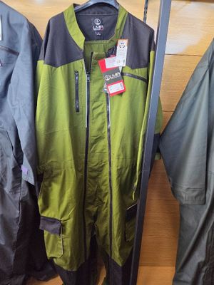 two jackets and a pair of skis hanging on a rack