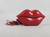 a close up of a red lipstick shaped object on a white surface