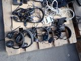 a pile of headphones and a laptop on a pallet