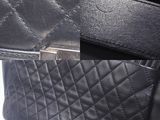 an image of a black purse with a silver buckle