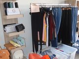a room filled with lots of clothes and bags